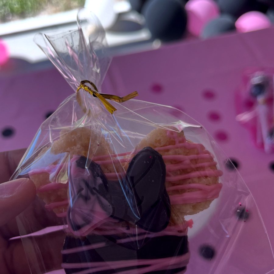 Chocolate-dipped Rice Krispies treat with pink drizzle